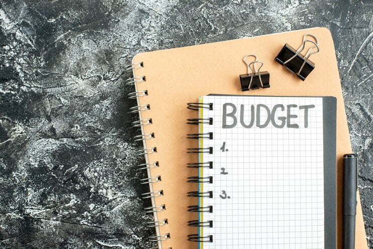 top-view-budget-written-note-notepad-with-pen-dark-surface-student-color-school-money-gray-college-copybook_179666-19729